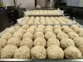 Grandi vassoi pieni di canederli dolci trentini pronti per essere cucinati.