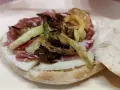 Puccia leccese con salumi, formaggio e verdure grigliate, un sapore autentico del Salento.