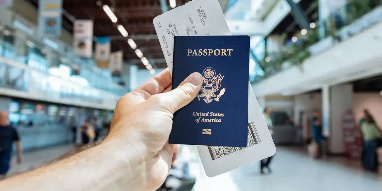 Passaporto USA e boarding pass pronti per il viaggio. L'aeroporto fa da sfondo.
