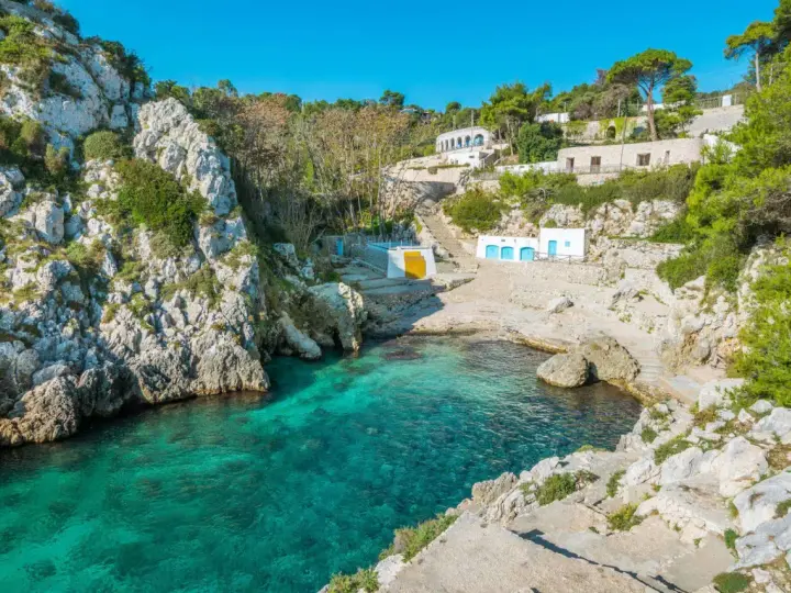 Baia con acque cristalline e case bianche, perfetta per un tour della Puglia in 5 giorni.