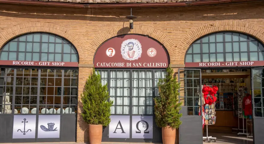 Ingresso alle catacombe di San Callisto, tra i più suggestivi siti di Roma. Due negozi di souvenir fiancheggiano l'entrata principale.