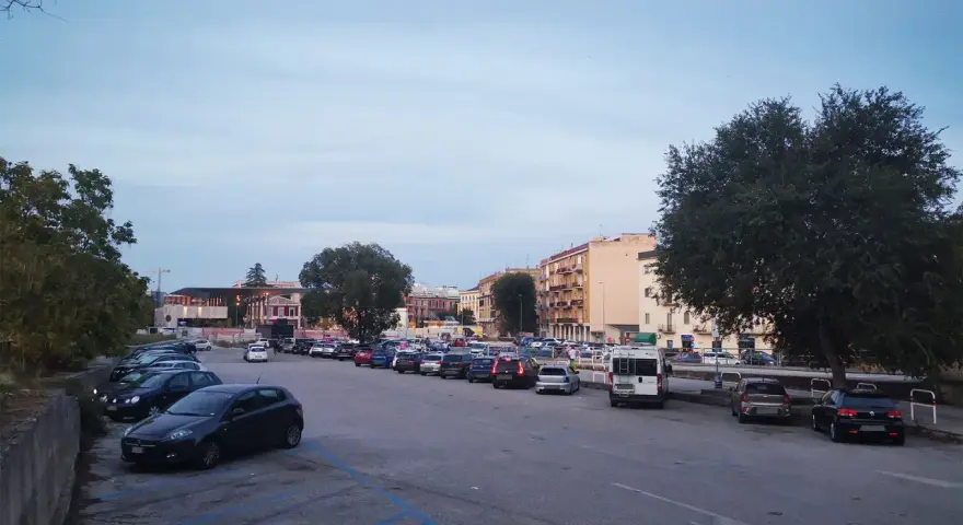 Ampio parcheggio a Matera, con molte auto parcheggiate in file ordinate. Ideale per chi cerca dove parcheggiare a Matera.