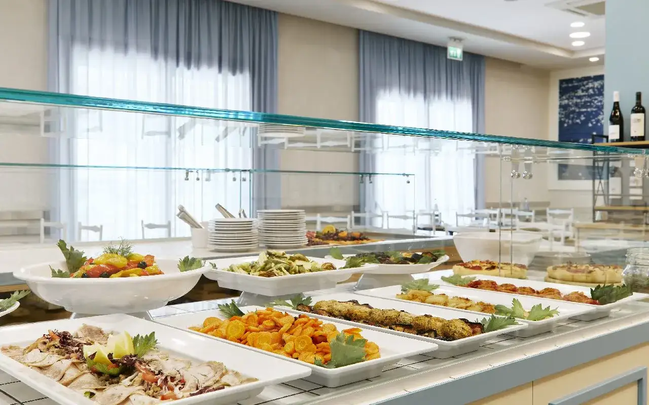 Buffet con pietanze varie: affettati, verdure, pasta, pizze. Un assaggio del pensione completa significato in un hotel.